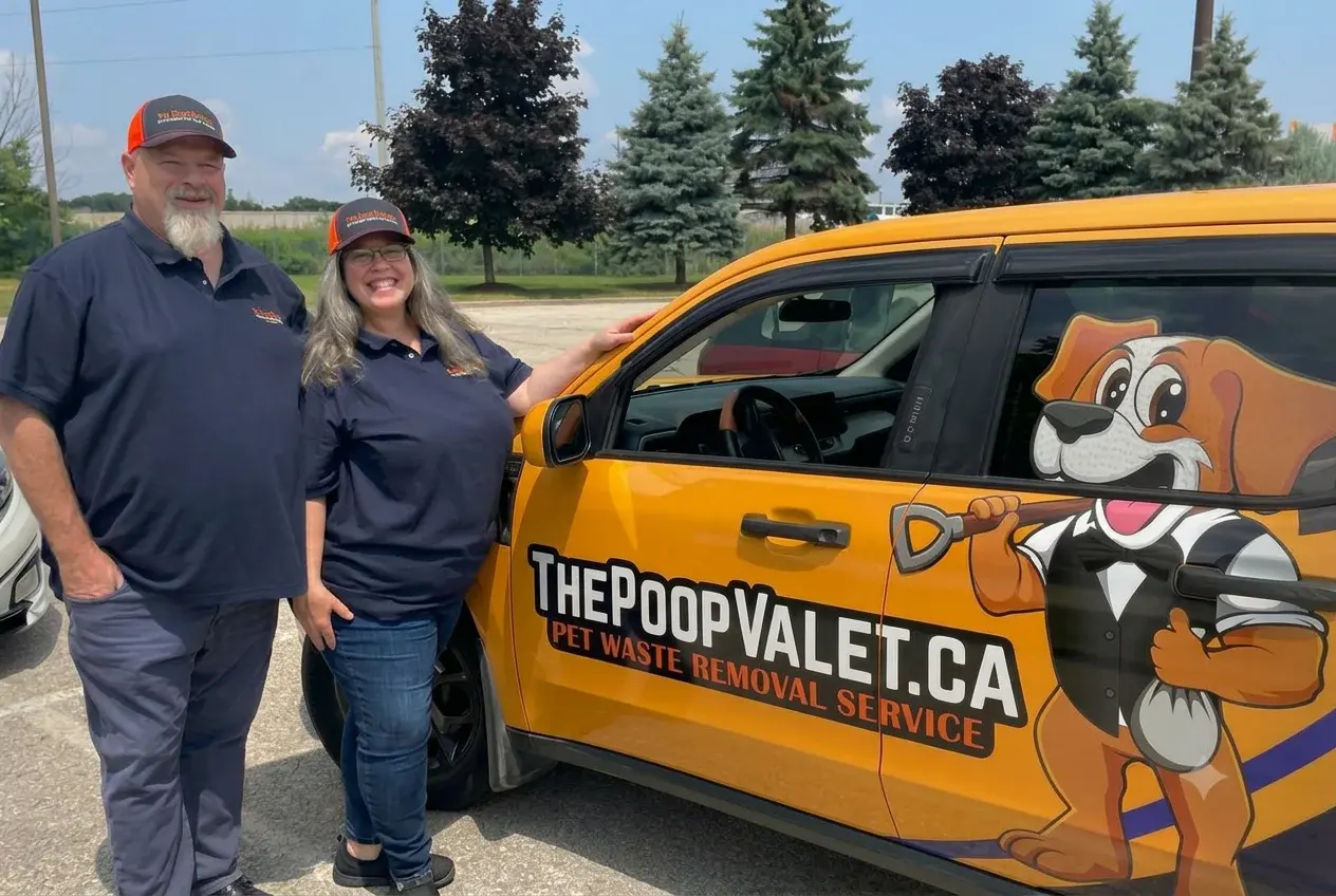 Rick and Sherry of The Poop Valet beside the service van