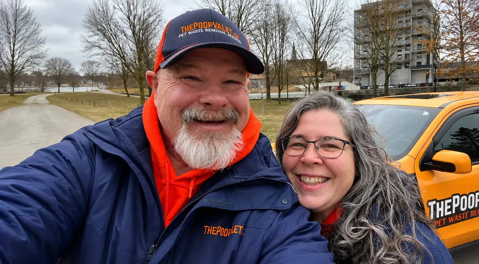 Rick and Sherry Couchman of The Poop Valet with their service truck